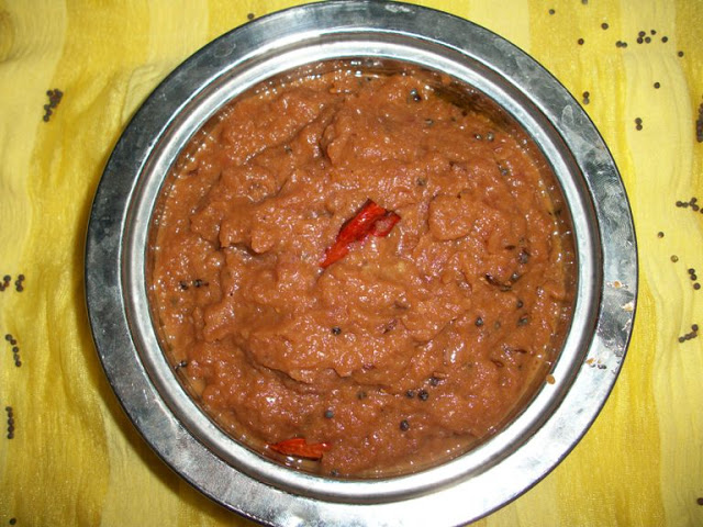 Onion Chutney in a steel bowl with a dry red chilli and mustard tempering