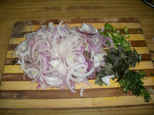 onions sliced thinly. green chillies, coriander leaves and curry leaves