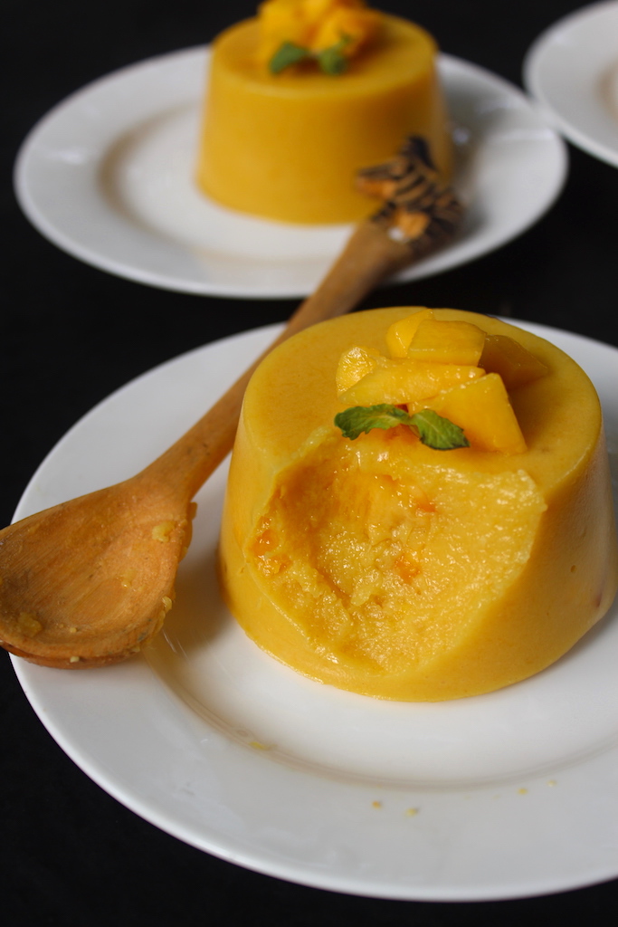 mango pudding scooped with a spoon to show the texture