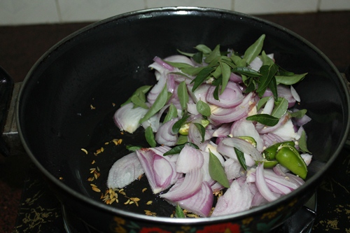 add in onions, green chillies and curry leaves