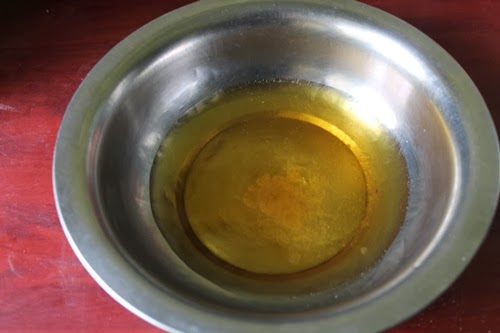 take melted ghee in a bowl for whole wheat biscuits