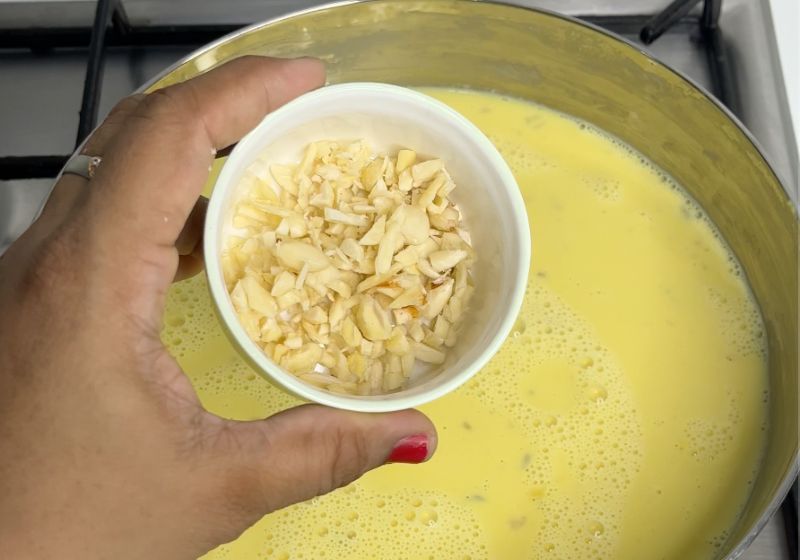add chopped nuts into badam milk for texture for making badam milk or badam doodh