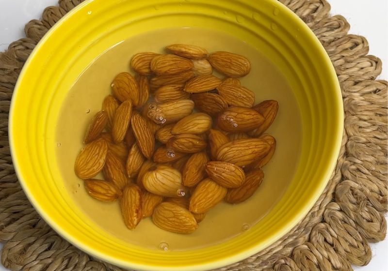 soak almonds in warm water for making badam milk or badam doodh