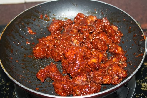 fried chicken coated with schezwan sauce