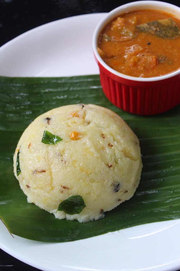 close shot of rava pongal served in banana leaf with sambar