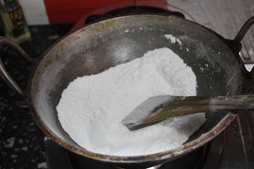 roasting rice flour in a iron kadai