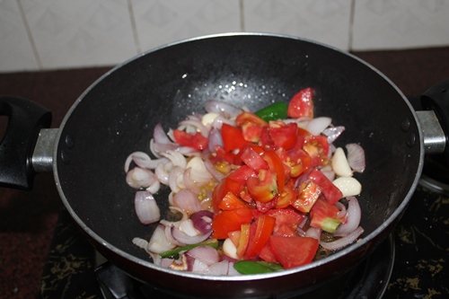 add tomatoes to onion mix