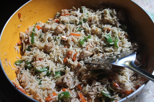 toss rice with chicken for fried rice