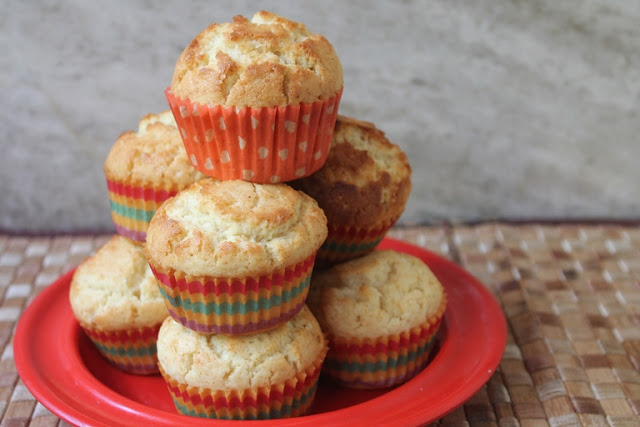 vanilla muffins with perfect muffin tops stacked on a red plate