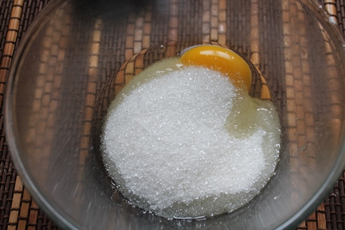 egg and sugar taken in a glass mixing bowl