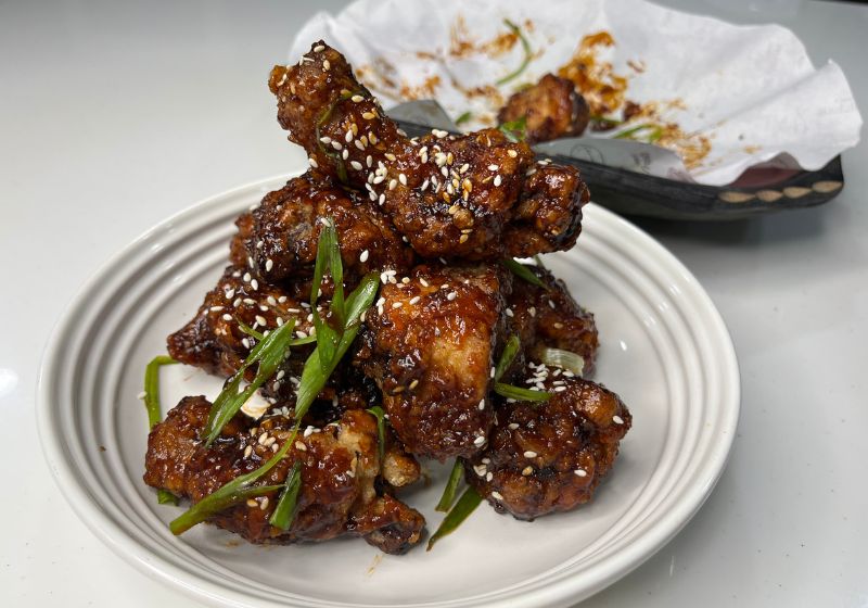 korean fried chicken plated with sesame seeds