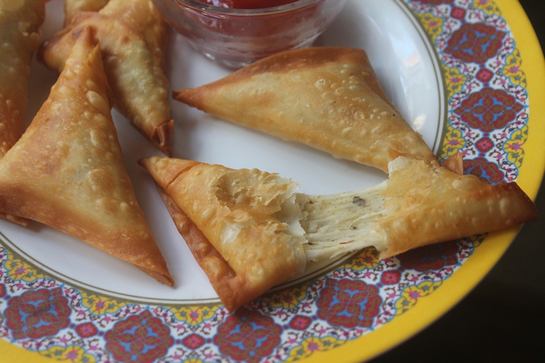 cheese samosa fried and strechy cheese shown