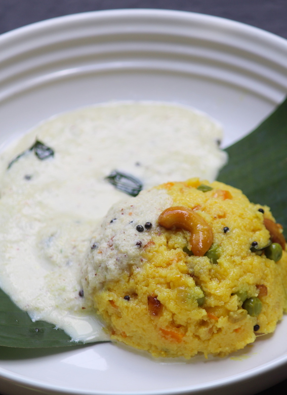 rava kichadi with coconut chutney poured on top