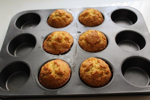 orange muffins baked in muffin tray