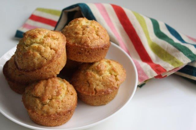 orange muffins displayed on a white plate