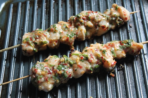 chicken kebab getting cooked in grill pan