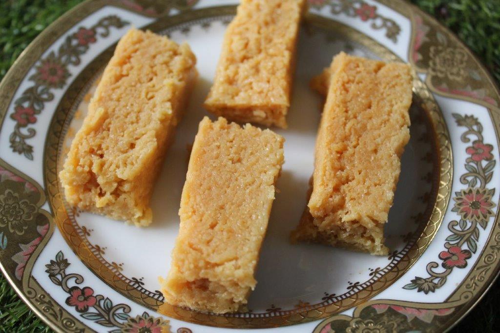 four bars of milk cake plated in a white plate