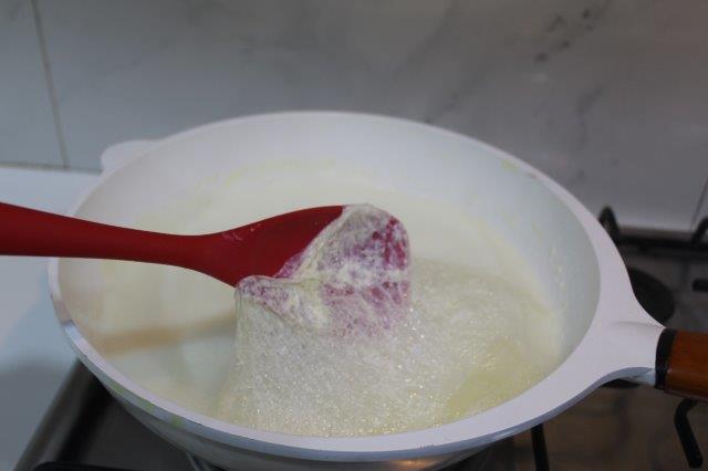 scrape the sides of the pan and fold in the malai which forms over the milk