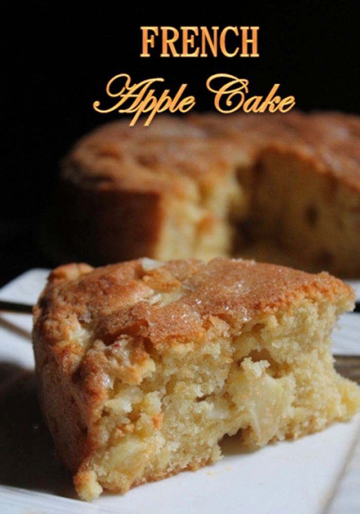 a slice of apple cake in front with apple cake behind
