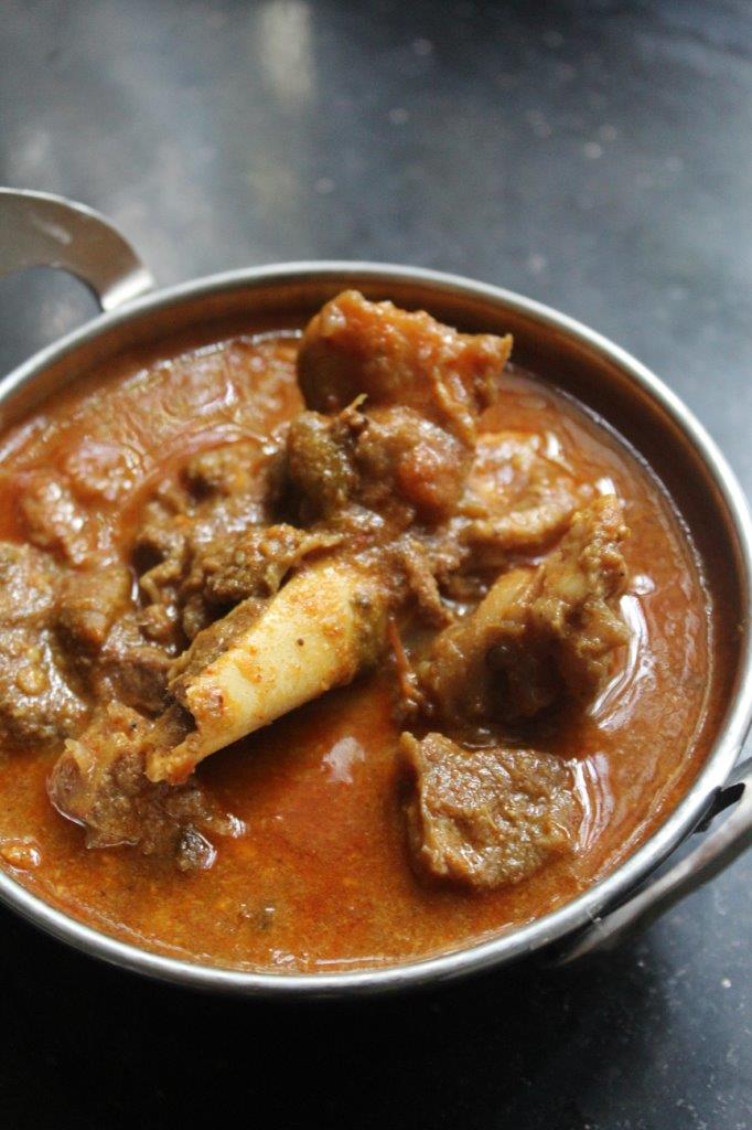 close look of spicy mutton kuzhambu or mutton kulambu served in a bowl