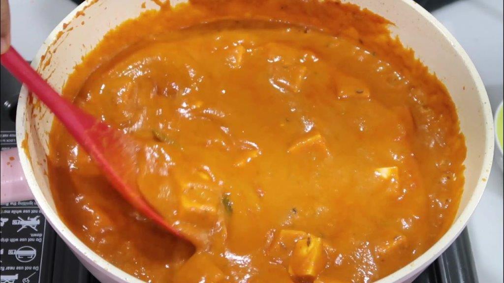 paneer butter masala curry simmering shot