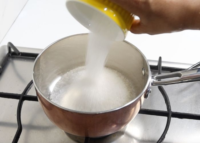 take sugar in a sauce pan