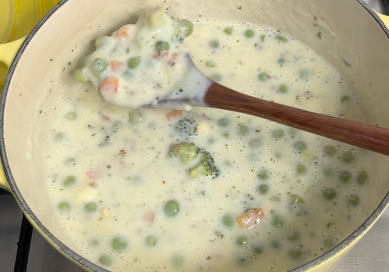 mix white sauce with cheese and vegetables