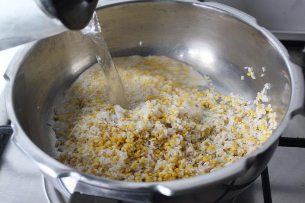 add rice and dal to pressure cooker along with water for making sweet pongal | sakkarai pongal