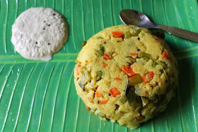 Rava upma with vegetables served in banana leaf plate with coconut chutney and a spoon