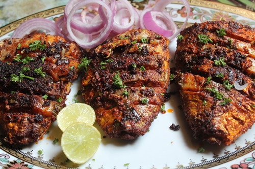 fried fish served with onion and lemon