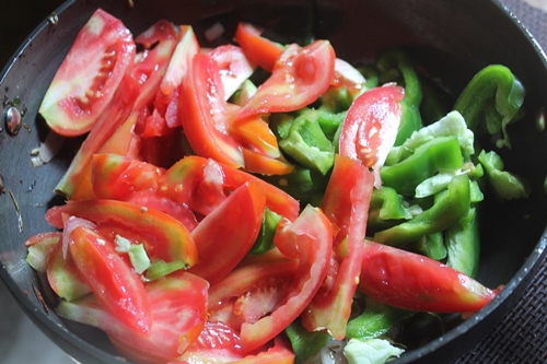 add in capsicum and tomatoes