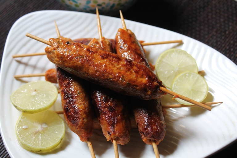 Chicken Seekh Kebab served with lemon wedges