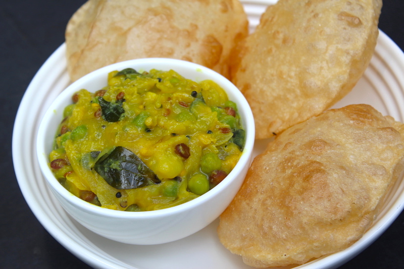 poori masala served with three puffed poori