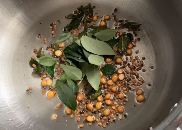 tempering whole spices in oil for poori masala