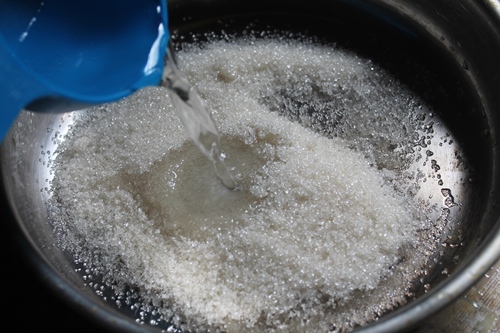 sugar and water in a pan for sugar syrup