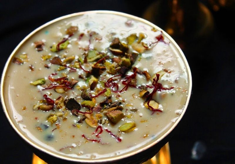 basundi served with nuts and saffron garnish