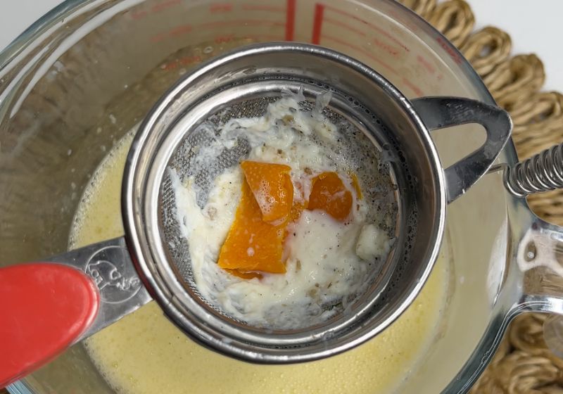 orange peel and cardamom skins strained in sieve