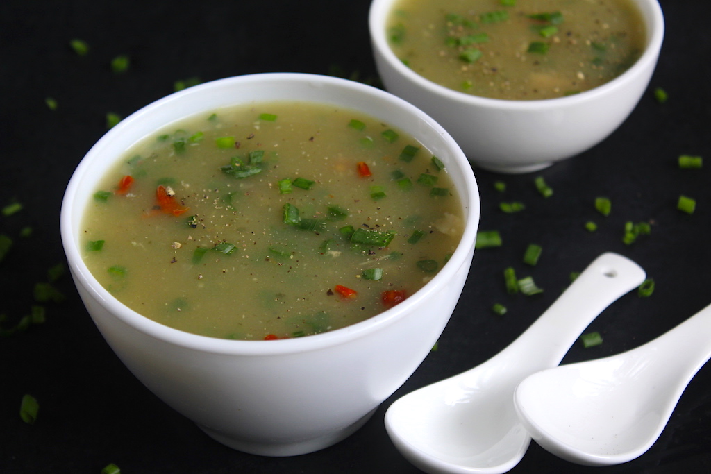 Two servings of chicken clear soup served in a soup bowl 