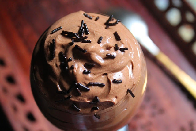 eggless chocolate mousse served in a stem glass with chocolate sprinkles on top