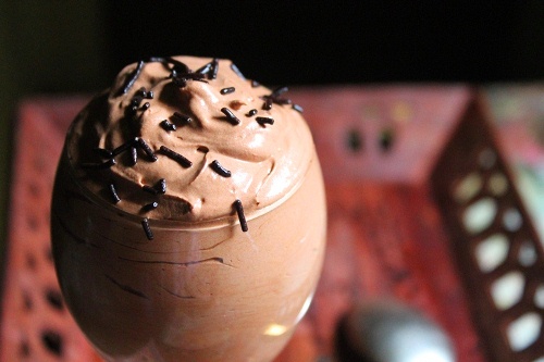 eggless chocolate mousse served in a stem glass with chocolate sprinkles on top