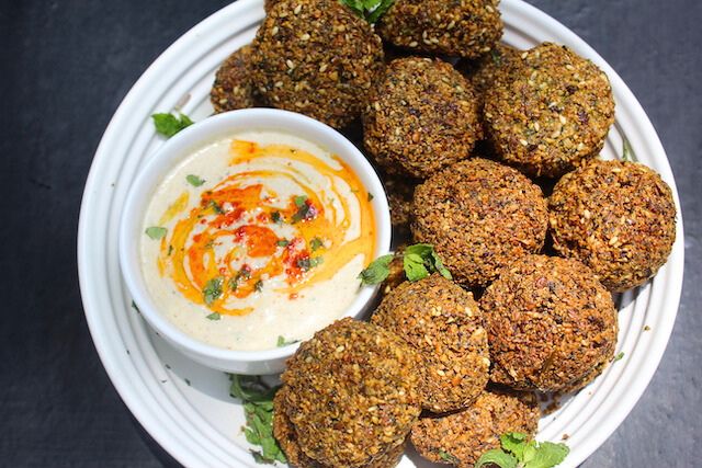 tahini sauce served with falafels with a drizzle of olive oil