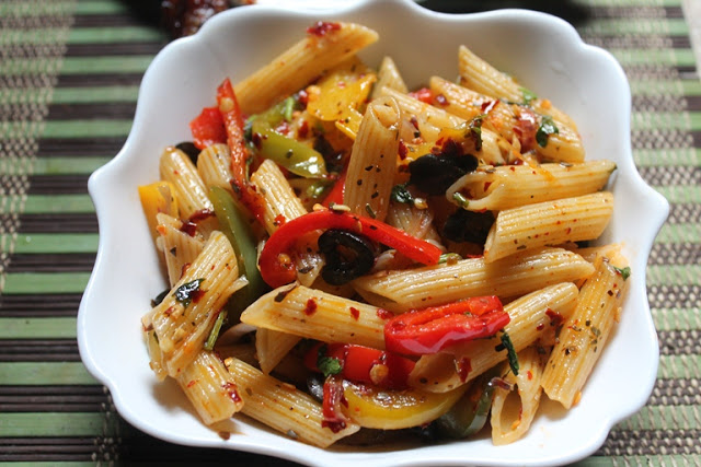 italian penne pasta served with olives and peppers