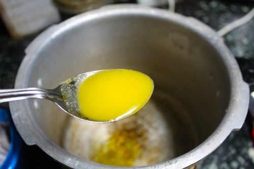 Heat ghee in a pressure cooker