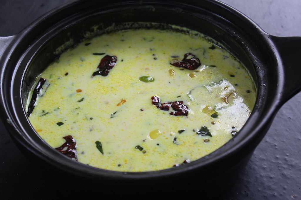 moru curry served on a clay pot