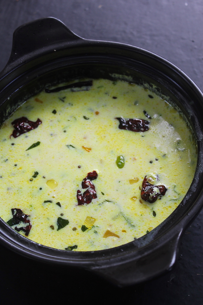 close shot of moru curry served on a clay pot