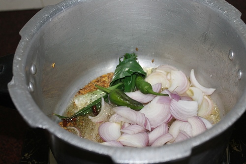 add in sliced onions, green chillies and bay leaf.