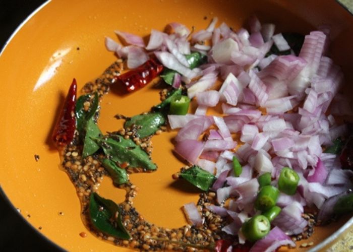 onions and green chillies are added in upma