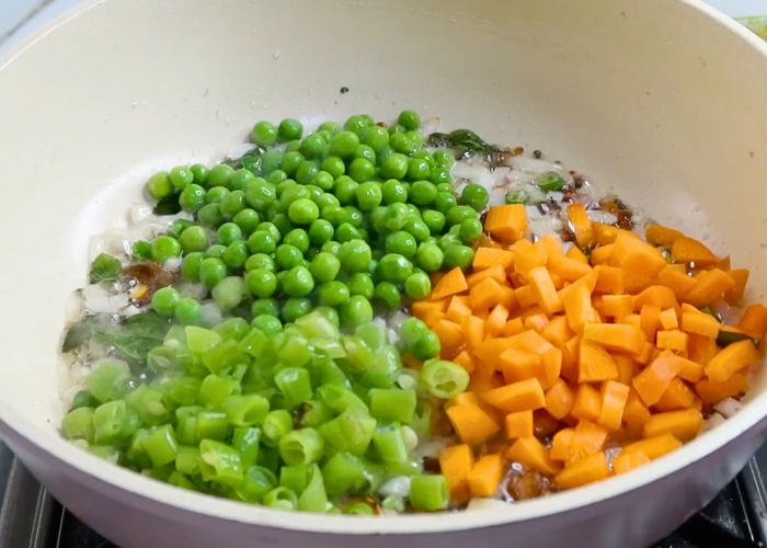 add in chopped vegetables carrots, beans and green peas