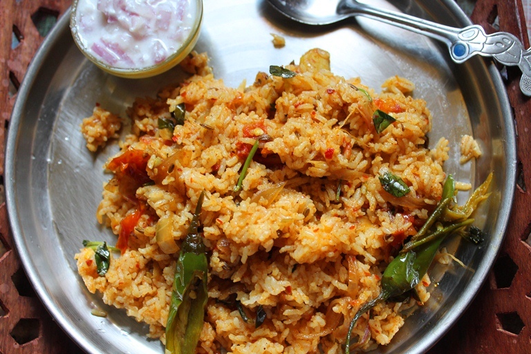 tomato rice or thakkali sadam served with onion raita