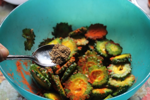 add garam masala and amchoor to make bitter gourd chips